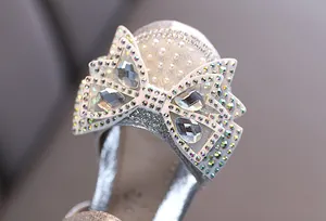 Detailed macro shot of sparkling rhinestone bow on girls' princess dance shoes