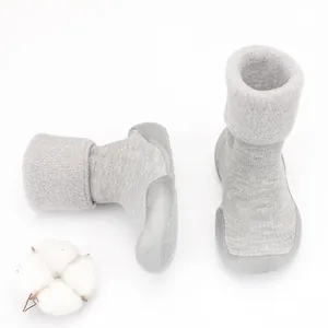 Close-up of grey baby winter fleece sock shoes with soft non-slip rubber sole for warmth