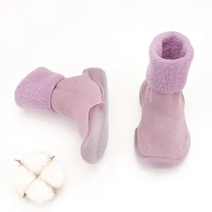 Macro view of purple baby walker shoes featuring soft lamb wool lining and rubber soles