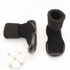 Detail view of black baby winter sock shoes with fluffy lamb wool cuffs and soft soles