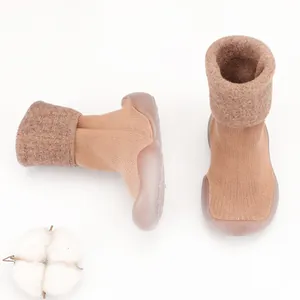 Close-up detail showing the warm knitted texture and soft lamb wool cuffs of baby walking shoes
