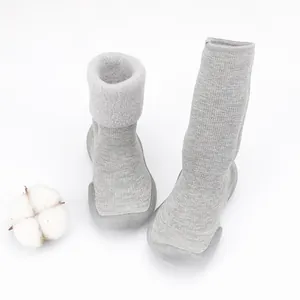 Detailed view of grey baby winter sock shoes with warm lamb fleece lining.
