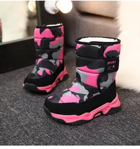 Vista detallada de botas de nieve camuflaje rosas para niños con forro polar.