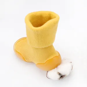 Close-up detail of soft yellow lamb wool knit baby walker shoes with non-slip rubber sole