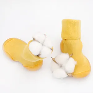 Detail of yellow knit baby sock shoes with natural cotton for soft texture