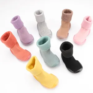 Detailed view of candy-colored lamb wool baby walker socks with non-slip soles.