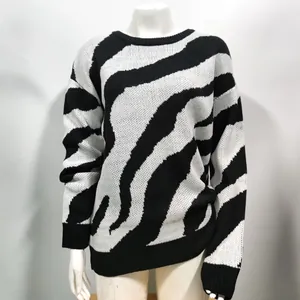 Close-up showing the bold black and white zebra pattern on a round neck knit sweater.