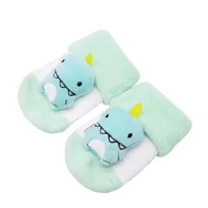 Gros plan sur un dinosaure en peluche 3D sur des chaussettes bébé antidérapantes