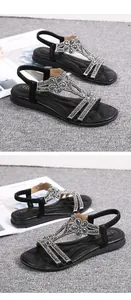 Close-up of black women's flat sandals with elegant grey rhinestone flower details.