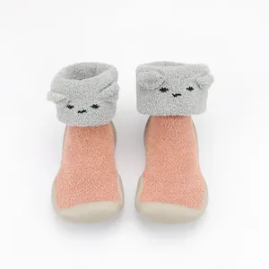 Detailed view of cozy pink coral fleece baby sock shoes with cute animal face design
