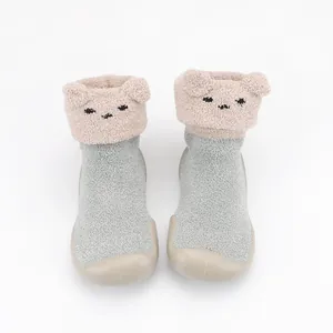Close-up of cute cartoon bear face detail on warm fleece baby indoor sock shoes