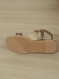 Bottom view of brown glitter flat sandal for women showing non-slip sole texture