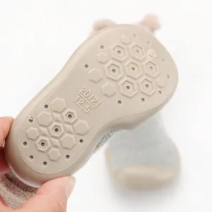 Close-up detail of soft non-slip sole on warm baby coral fleece sock shoes