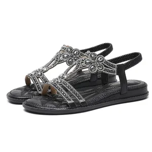 Elegant black flat sandals for women featuring sparkling rhinestone floral patterns