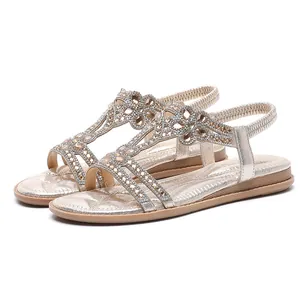 Elegant champagne gold women's flat sandals with sparkling rhinestone floral motifs