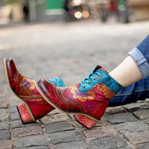 Gros plan sur des bottines ethniques vintage aux motifs floraux colorés et lacets.