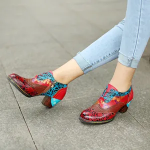 Detailed view of vintage ethnic floral print block heel shoes worn with light blue jeans
