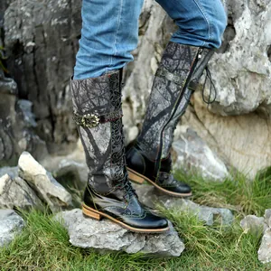 Vista detallada de botas altas planas con diseño de cordones y hebillas metálicas