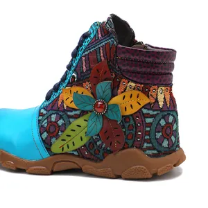 Close-up detail of bohemian retro women's ankle boot with vibrant floral embroidery
