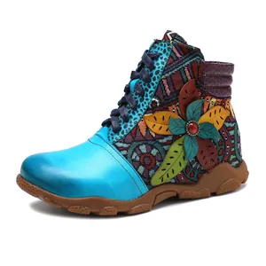 Detailed side view of vintage bohemian women's ankle boots with a colorful leather flower