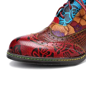 Close-up detail of ethnic style high-heeled shoe with floral prints and brogue patterns