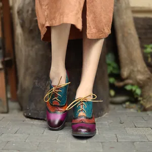 Detailed view of vintage leather color-block brogue heels worn with a stylish brown skirt