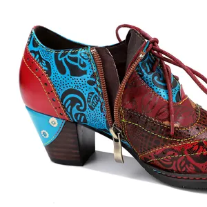 Detailed close-up of vintage ethnic floral patchwork high heel shoes with side zipper