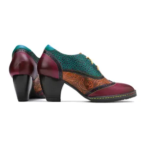 Detailed side view of vintage patchwork leather brogue high heels with paisley print.