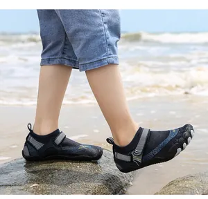 Side view of children's quick-dry water shoes worn on a rocky beach setting