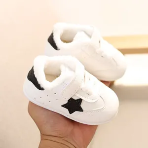 Cozy white baby winter sneakers with black star detail and warm fleece lining