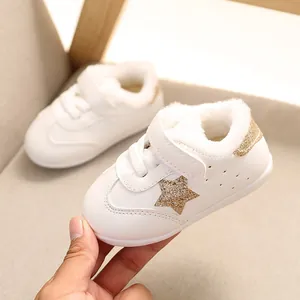Warm white fur-lined baby sneakers with gold glitter stars for infants aged 0-2