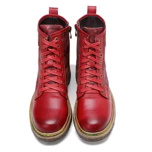 Gros plan détaillé des bottes de motard gothiques vintage en cuir rouge avec lacets.