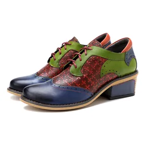 Detail of vintage patchwork Brogue shoes with colorful floral pattern and thick heel.