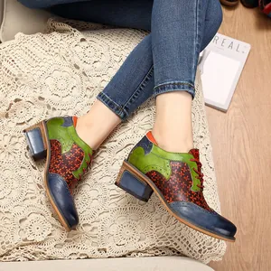Detailed view of colorful vintage ethnic style leather brogues with chunky block heels