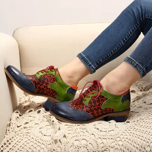Close-up of retro ethnic patchwork Brogue shoes with floral patterns and leather laces.