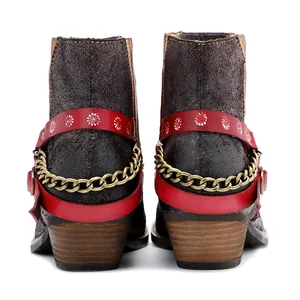 Vue arrière détaillée de bottines en daim marron avec bride rouge et chaîne or