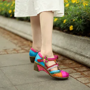 Close-up detail of vintage colorful floral Mary Jane wedge sandals with T-strap