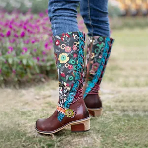 Detail of vintage floral ethnic knee-high boots with adjustable lace-up back