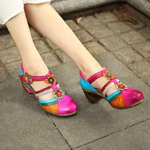 Close-up view of colorful retro Mary Jane sandals featuring floral patterns and wedge heels