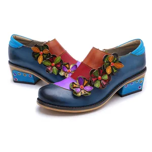 Detail view of vintage color-clash leather shoes with intricate flower appliqués