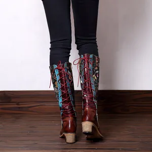 Close-up detail of vintage ethnic floral knee-high boots featuring back lace-up design