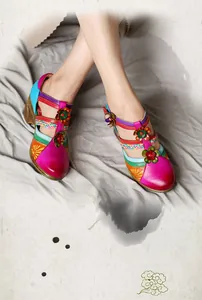 Detail shot of colorful retro Mary Jane wedge sandals with 3D leather flower accents.