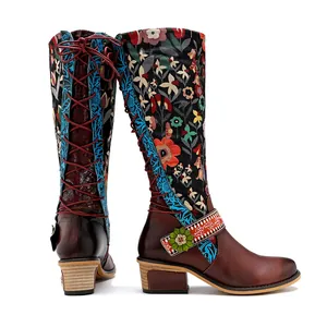 Detail of retro ethnic knee-high boots with floral patterns and lace-up back