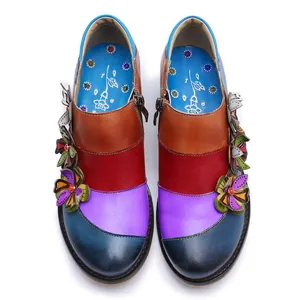 Top view of vibrant colorful patchwork leather shoes with handmade floral decorations