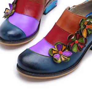 Detail view of colorful vintage patchwork leather shoes with 3D floral appliques