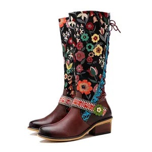 Retro ethnic knee-high boots featuring vibrant floral print and brown leather details