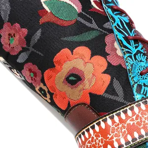 Vivid detail of retro colorful floral embroidery on ethnic style tall knee-high boots
