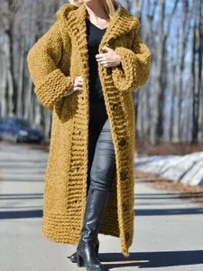 Macro detail of oversized long chunky knit hooded cardigan in mustard yellow for winter