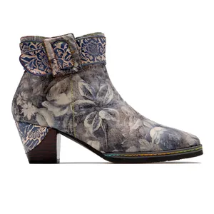 Detailed view of vintage Chinese floral pattern and buckle on blue leather ankle boot