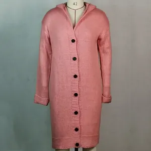 Macro view of pink long hooded chunky knit cardigan featuring large black buttons and cuffs